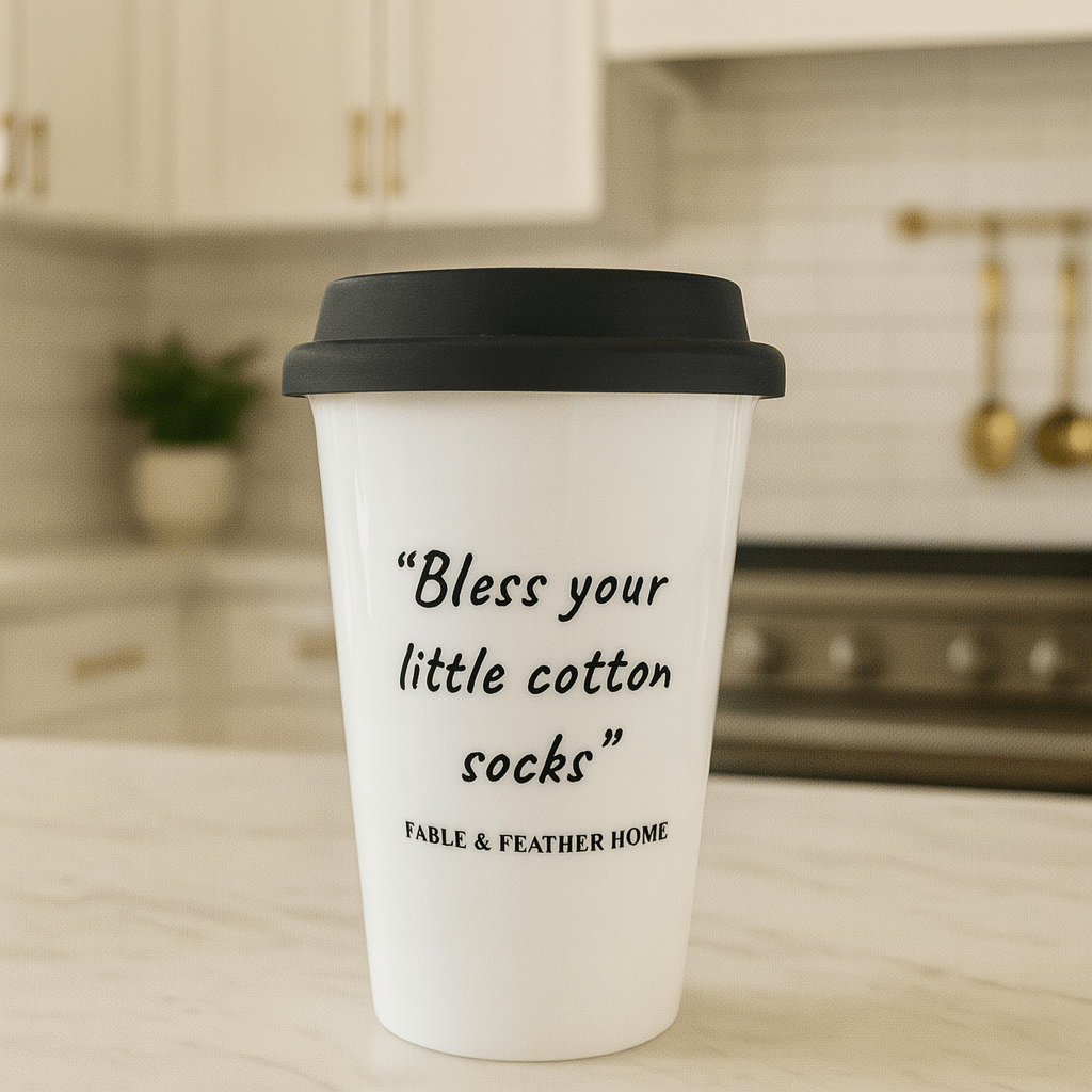 Bless Your Little Cotton Socks ceramic mug displayed on a marble kitchen countertop.