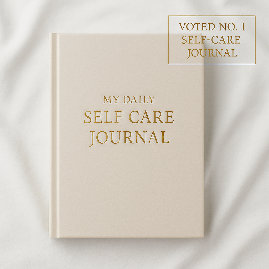 Daily Self-Care Journal hardcover with gold foil title on white background – luxury wellness notebook.