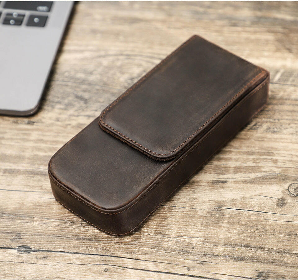 Brown leather pen holder with visible hand-stitching