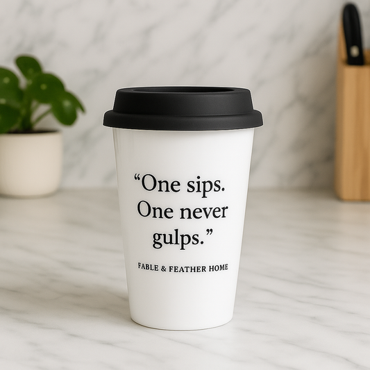 One Sips, One Never Gulps ceramic mug on a marble kitchen countertop.