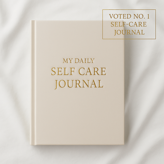Daily Self-Care Journal hardcover with gold foil title on white background – luxury wellness notebook.