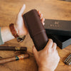 Luxury brown leather travel cigar case on wooden table
