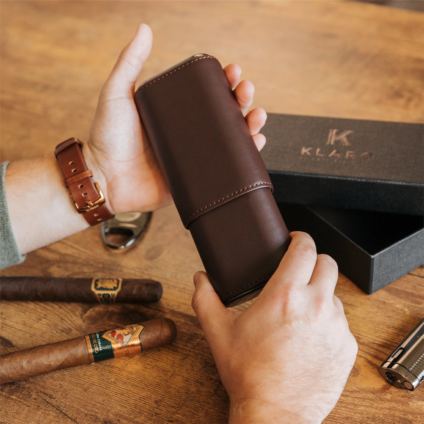Luxury brown leather travel cigar case on wooden table