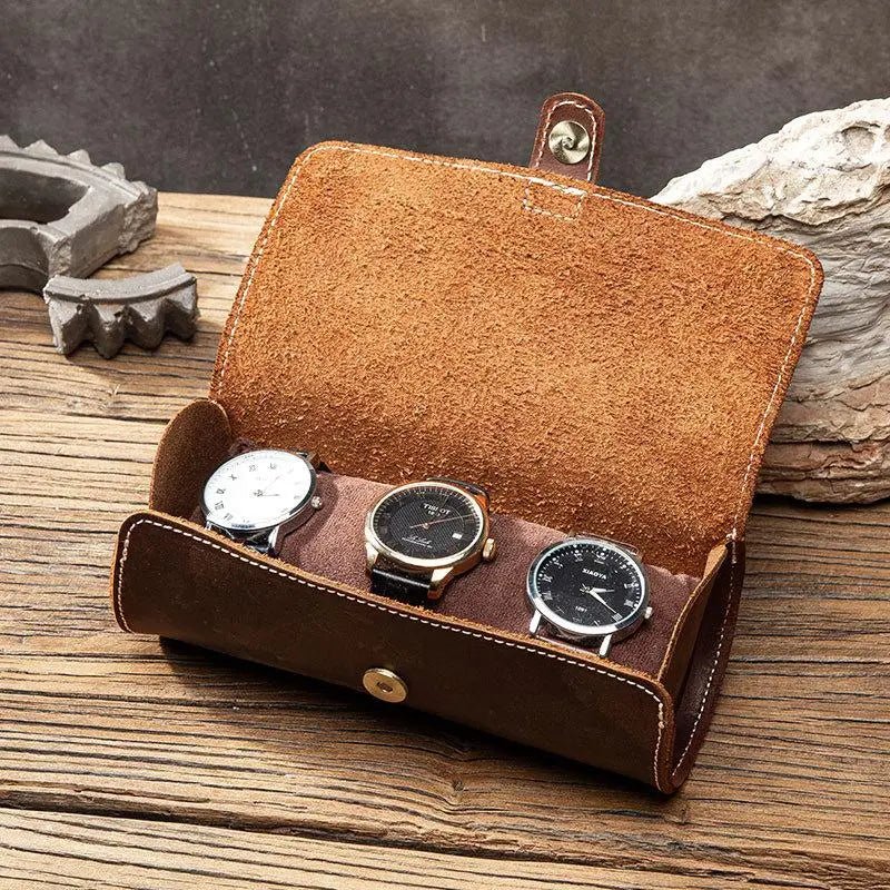 Brown leather watch roll with suede lining and three compartments
