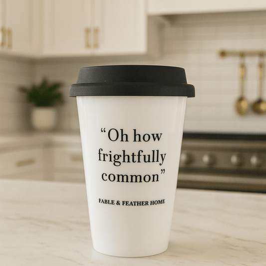 Oh how frightfully common ceramic mug resting on a marble kitchen countertop with a clean, bright background.