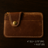 Handmade leather card holder with snap closure and stitching detail
