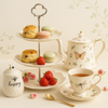 Round embossed tiered cake stand with pastries and tea set