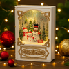 Snowman Family Christmas Storybook Light glowing with LED illumination, styled with festive baubles and twinkle lights on a holiday backdrop.