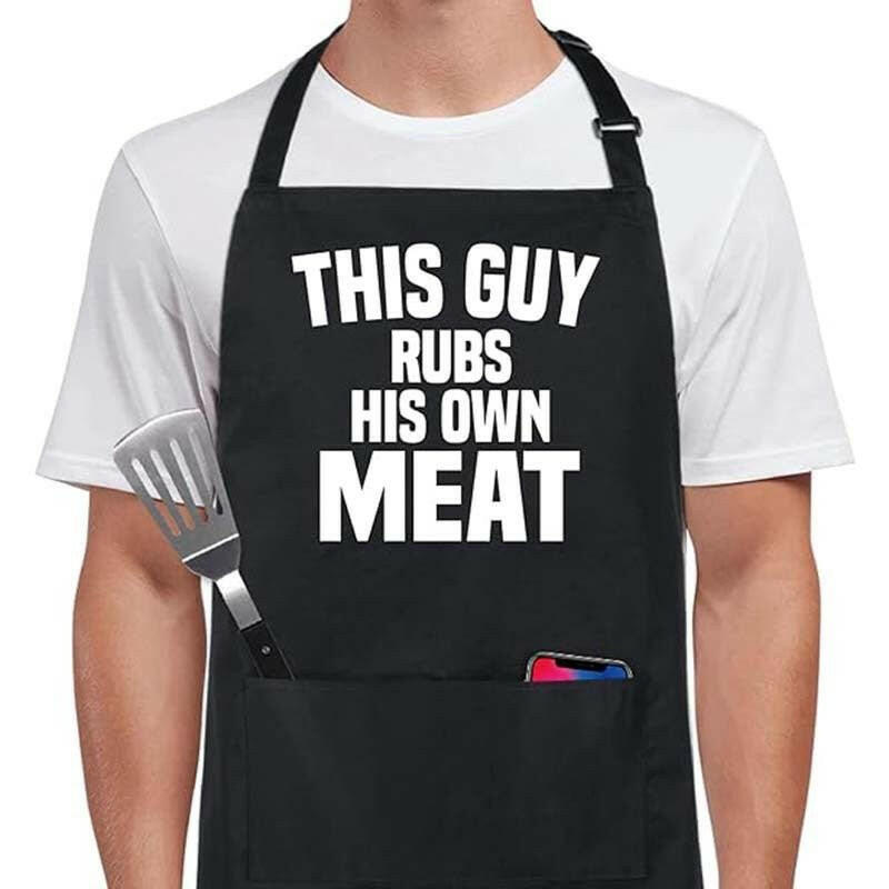 Funny BBQ apron with white text saying ‘This Guy Rubs His Own Meat’ on black cotton.