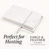 Marble cheese slicer on white background with Perfect for Hosting text and Fable & Feather Home logo.