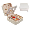 Travel jewelry case filled with rings, earrings, and necklaces – compact design for storage and travel.