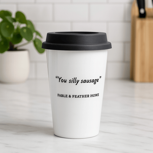 You Silly Sausage ceramic mug sitting on a marble kitchen countertop with a bright, clean background.