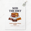 White tea towel with Sod the Diet text and Victoria sponge cake illustration on marble background.