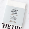 Fable & Feather Home tea towel with belly band packaging – Sod the Diet design on marble background.