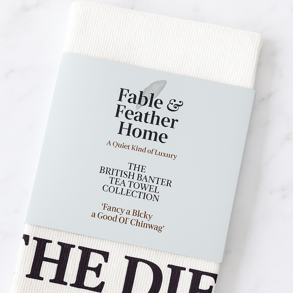 Fable & Feather Home tea towel with belly band packaging – Sod the Diet design on marble background.
