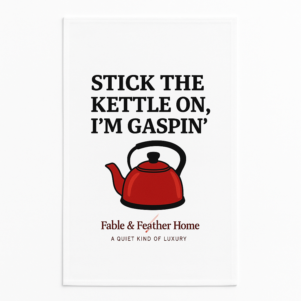 White tea towel with red kettle and text “Stick the kettle on, I’m gaspin’” by Fable & Feather Home